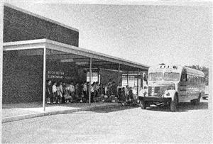 front with bus and students 